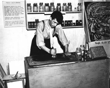 Paul Holmes Coates grinding colors for use in a fresco painting by Diego Rivera